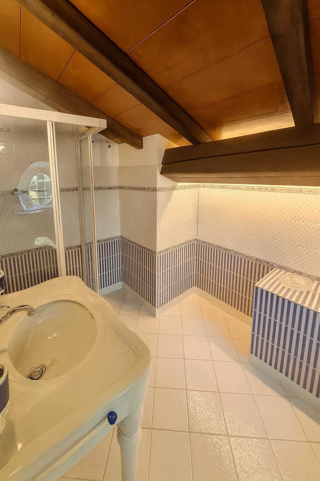 A bathroom with a bathtub, a shower, and a sink.