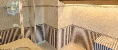 A bathroom with a bathtub, a shower, and a sink.