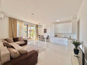 Deluxe Apartment | Living area | 42-inch LCD TV with satellite channels