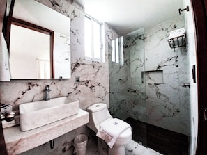 Separate bathtub and shower, towels, soap, shampoo