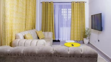 Classic Apartment, City View | Living area | 32-inch Smart TV with digital channels