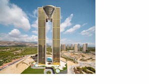 Un immeuble de grande hauteur doté d’une architecture originale, entouré d’un espace paysager agrémenté de sentiers et de verdure.
