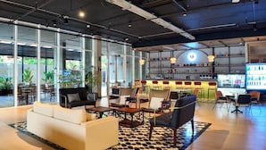 A modern lounge area with seating, a bar, and large windows. - Faranda Collection Cartagena, a member of Radisson Individuals (Cartagena)