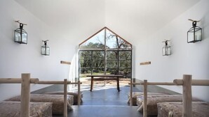 A room with a large window, wooden beams, and a bench. - Luz Charming Houses (Fatima)