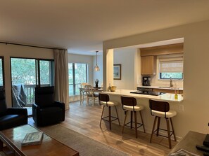 Un appartement moderne comprenant un salon, un coin repas et une cuisine.