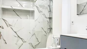 Shower, towels, soap, toilet paper
