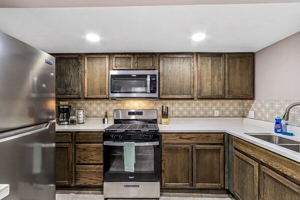 Fridge, microwave, cookware/dishes/utensils, dining tables
