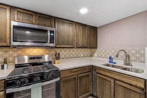 Fridge, microwave, cookware/dishes/utensils, dining tables