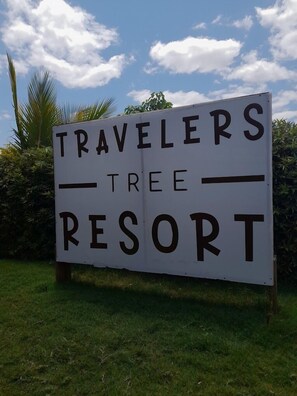 A sign for Travelers Tree Resort.