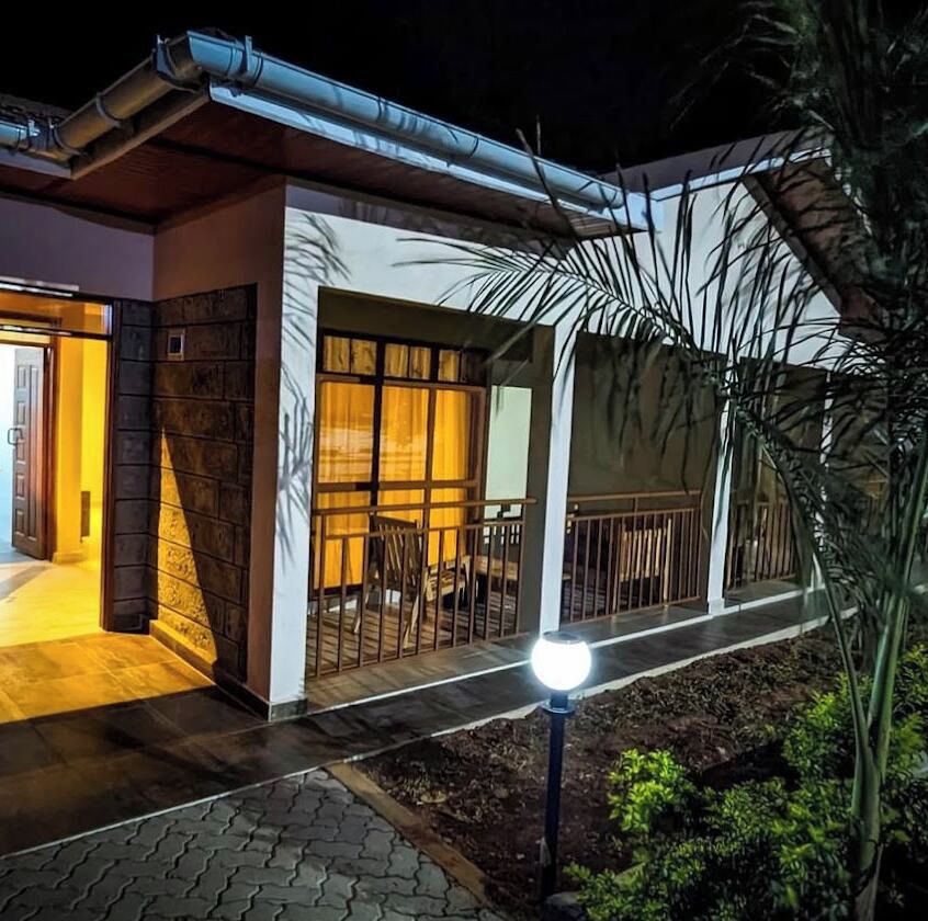 A house with a porch, a dining area, and a visible entrance.