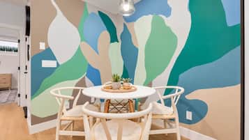 A round table, a colourful mural and time for one more coffee. This little dining nook has plenty of personality.