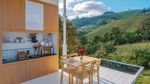 A modern kitchen with wooden cabinets and a dining area with a table and chairs.