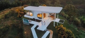 A modern house with a flat roof, large windows, and a spacious outdoor area.