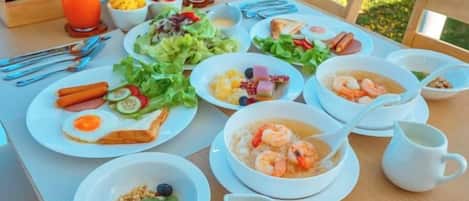 A breakfast table with various dishes, including eggs, toast, and a bowl of soup.