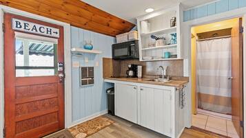 Coffee/tea maker, fridge, cookware/dishes/utensils