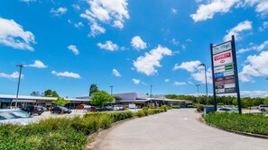 A commercial area with a supermarket named 'Cornetts Supermarkets' and a medical center. - Sandstone Point Cove Studio (SANDSTONE POINT)