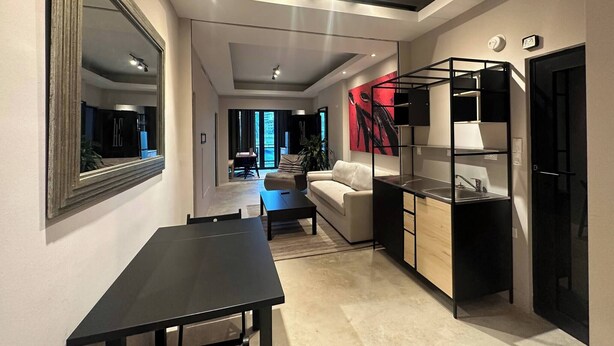 A modern kitchen with a black countertop and a built-in oven. - 4 bedroom 3 bathroom apt E (San Juan)