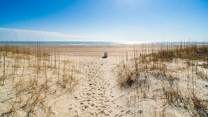 A sandy beach with a clear sky and a path leading to the water. - Dune View|Indoor Pool·Beachfront·Hot Tub·AB Condo (Atlantic Beach)