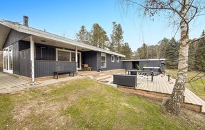 A modern house with a covered patio, a deck, and a small outdoor seating area. - Awesome home in Ebeltoft with WiFi (Ebeltoft)