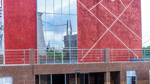 A building with a red facade, a large glass window, and a reception area. - H3 Hotel and Events Centre. (Abeokuta)