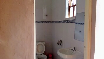 Ducha, artículos de tocador gratuitos, pantuflas, toallas
