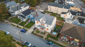 An aerial view of a residential neighborhood with houses, a swimming pool, and a street with cars. - The Old Fashioned | Hot Tub, Fire Pit, Mini Golf Steps From Bardstown Rd (Louisville)