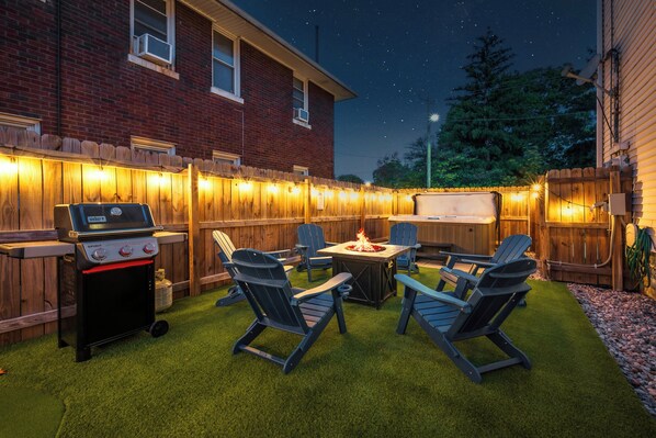 An outdoor patio with a grill, chairs, and a fire pit. - The Old Fashioned | Hot Tub, Fire Pit, Mini Golf Steps From Bardstown Rd (Louisville)