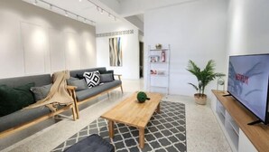 A modern living room with a sofa, coffee table, and TV. - Petaling Jaya 5 BedRoom Landed SS17/ for up to 18pax/Jaya1/Phileo/UM (Petaling Jaya)