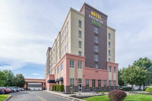 A multi-story hotel building with a sign indicating executive suites.