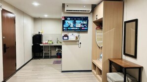 A compact hotel room with a kitchenette, a desk, and a TV mounted on the wall. - All-You-Need Room for 4 Walk & Drive Around to Tourist Hotspot Eden (Melaka)