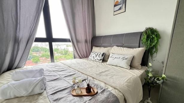 A neatly made bed with a tray, a potted plant, and a view of the outdoors. - RiverView 8Pax 3Br in KBtown PS4, Netflix A-1-2 (Kota Bharu)