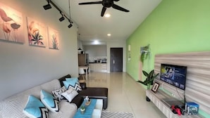 A modern living room with a sofa, coffee table, and TV. - RiverView 8Pax 3Br in KBtown PS4, Netflix A-1-2 (Kota Bharu)