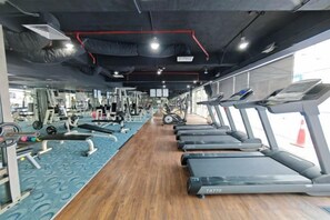 A gym with treadmills, weight machines, and a mirrored wall. - Meetsuite at Kota Kinabalu (Kota Kinabalu)