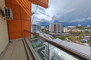 A balcony with a city view, a railing, and a building with a glass facade. - Meetsuite at Kota Kinabalu (Kota Kinabalu)