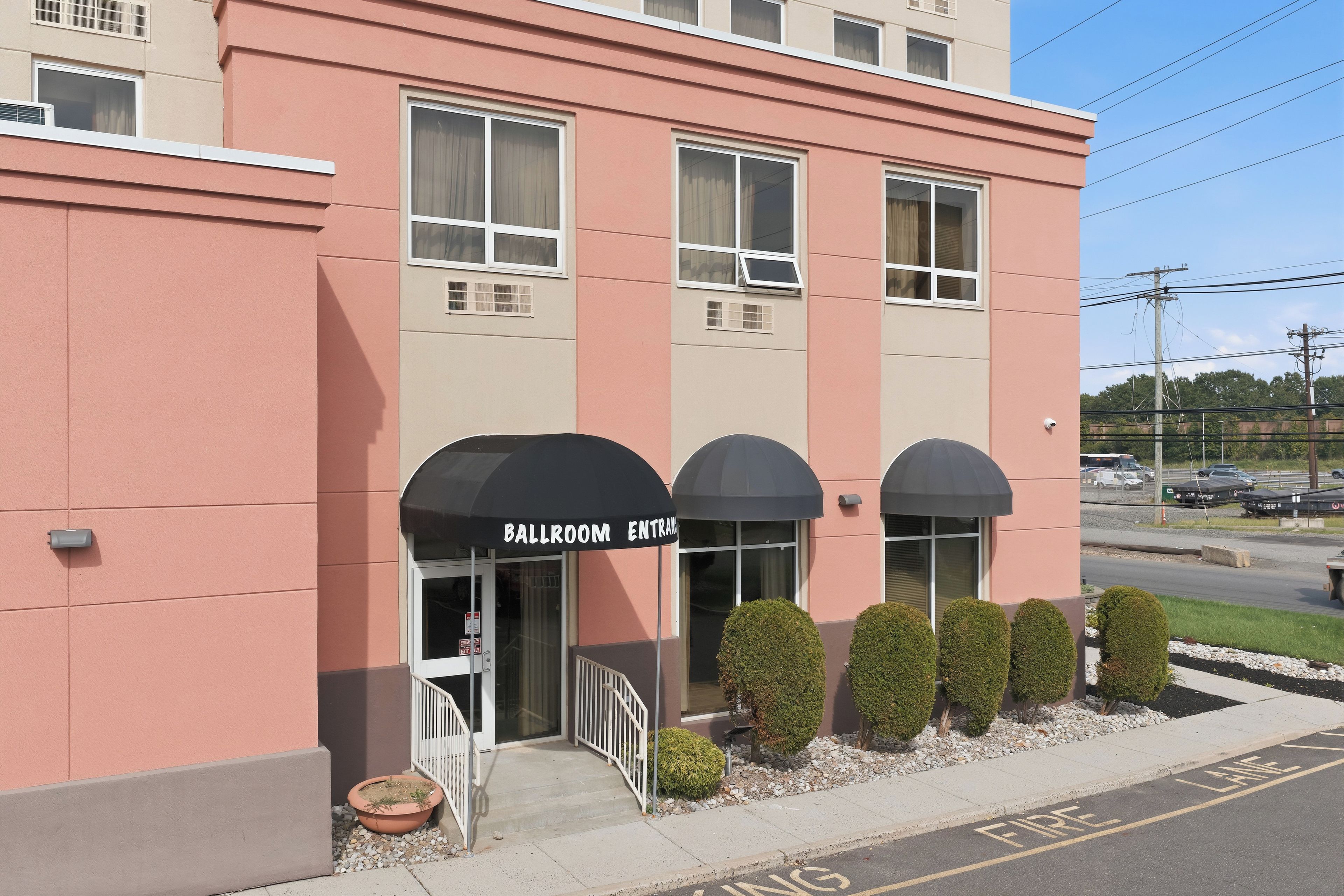 A building with a 'Ballroom Entrance' sign, a gated entrance, and a fire lane on the street.