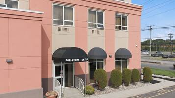 A building with a 'Ballroom Entrance' sign, a gated entrance, and a fire lane on the street.