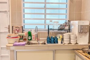 A kitchen with a sink, a dish rack, a water dispenser, and various kitchen items. - Golden Sweet Home @ CH Golden Hills (Night Market) - 2 Storey Terrace House (Brinchang)