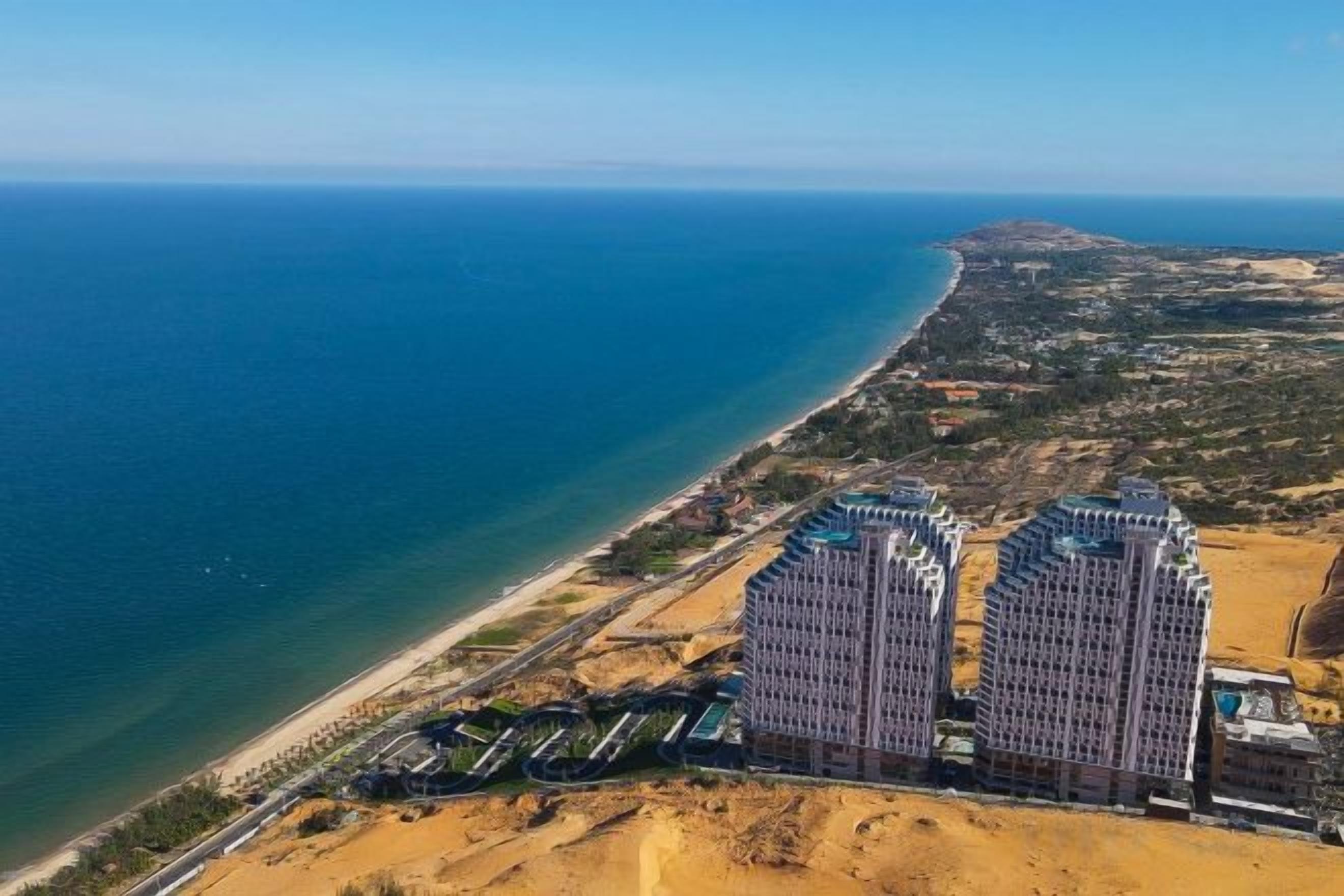 A high-rise hotel with a view of the coastline.