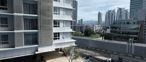 A modern building with a rooftop pool and a view of the cityscape.