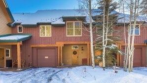 A two-story house with a garage, a front porch, and a snow-covered driveway. - Ski Tip #8723 : 2 (Keystone)