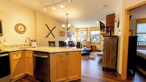 A spacious kitchen with wooden cabinets, a granite countertop, and a built-in dishwasher. - Sm8223-1 (Keystone)
