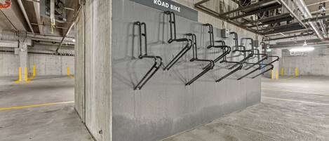 A concrete structure with a sign reading 'ROAD BIKE' and multiple bike parking bars.