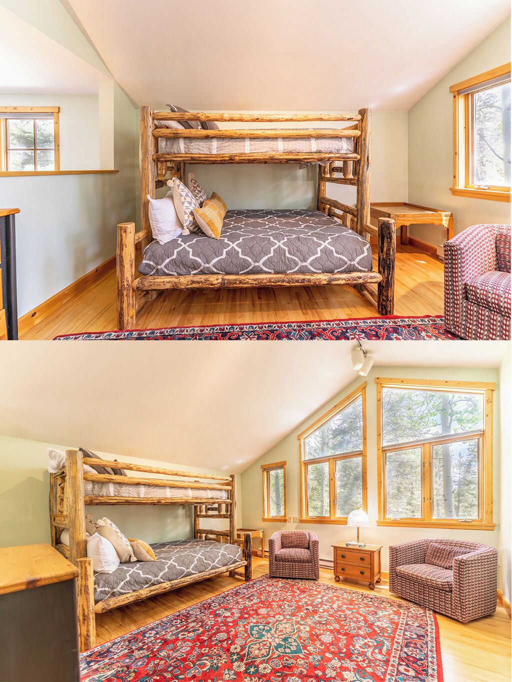 A bunk bed room with a red patterned rug, wooden furniture, and large windows.
