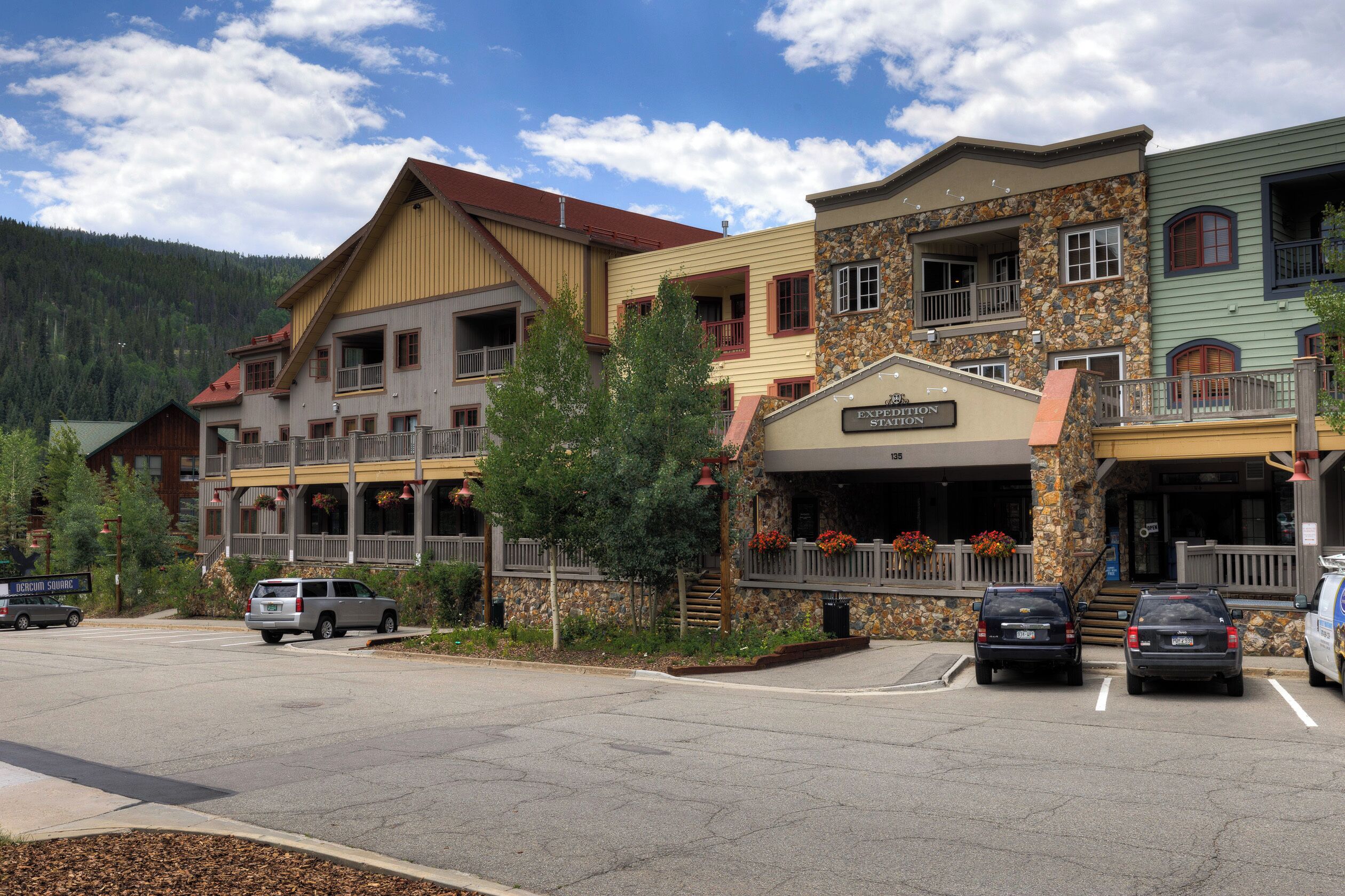 A multi-story building with a stone facade and a sign reading "EXPERIENCE STATION".
