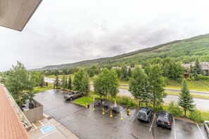 A parking area with a view of a green hillside and a road. - Gateway #5098 (Keystone)