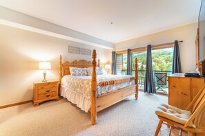 A bedroom with a four-poster bed, a wooden nightstand with drawers, a chair, and a wooden cabinet. - Gateway #5098 (Keystone)