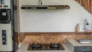 A kitchen with a gas stove, a built-in oven, a microwave, and a coffee machine. - Villa d'Alas Ubud (Bali)