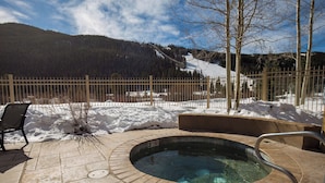 A hot tub with a view of a snowy mountain and a fenced area. - Red Hawk Lodge #2235 (Keystone)
