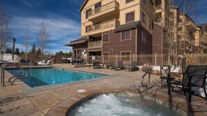 A hotel with a swimming pool, outdoor seating, and a hot tub. - Red Hawk Lodge #2235 (Keystone)