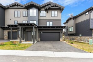 A modern two-story residential building with a garage, stone accents, and a well-maintained driveway. - 23fhs4 (Silverthorne)